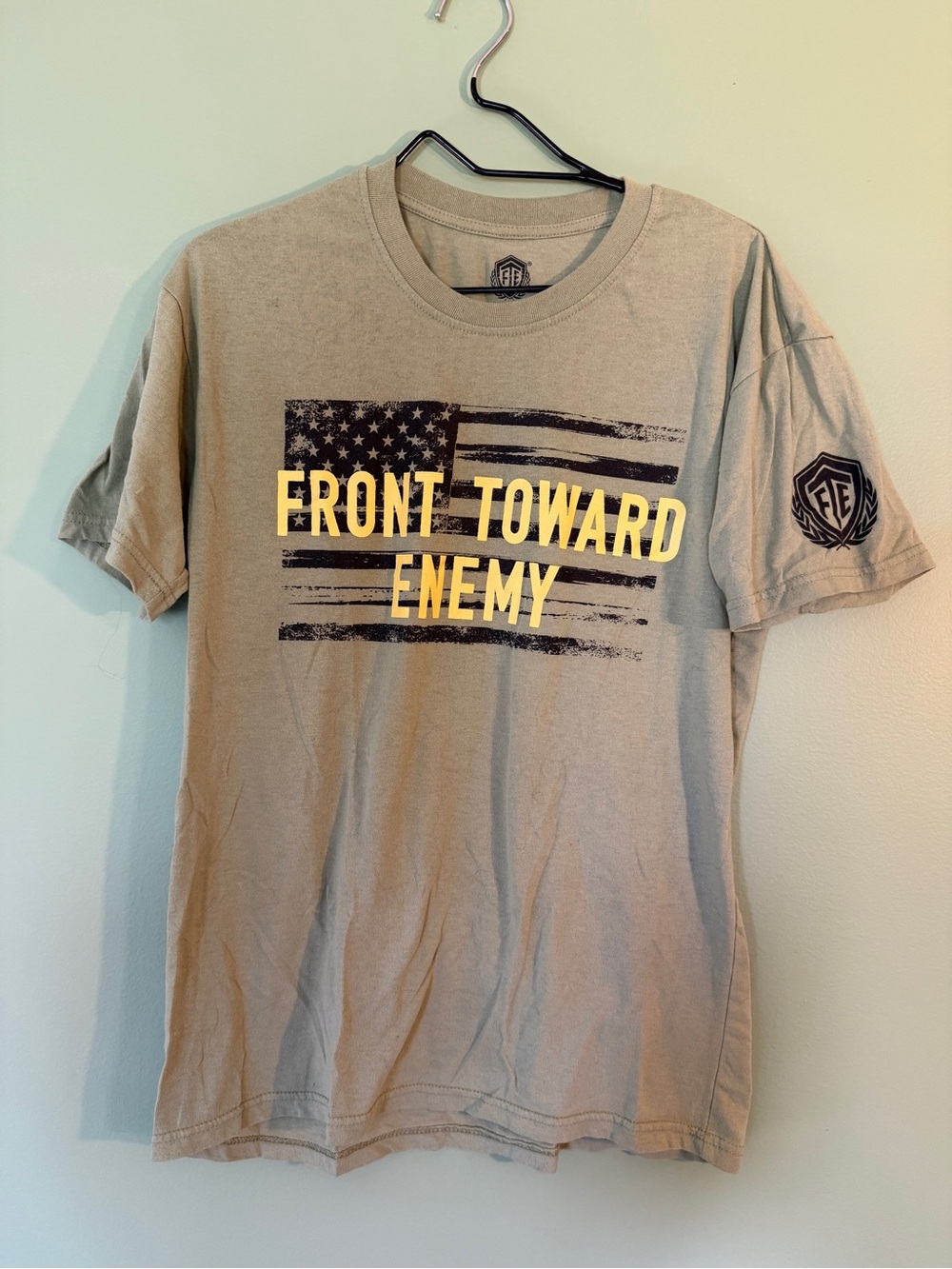 Front Toward Enemy Men's Light Green/Tan Graphic T-Shirt